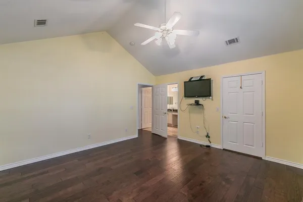 a view of a livingroom with wooden floor and a flat screen tv
