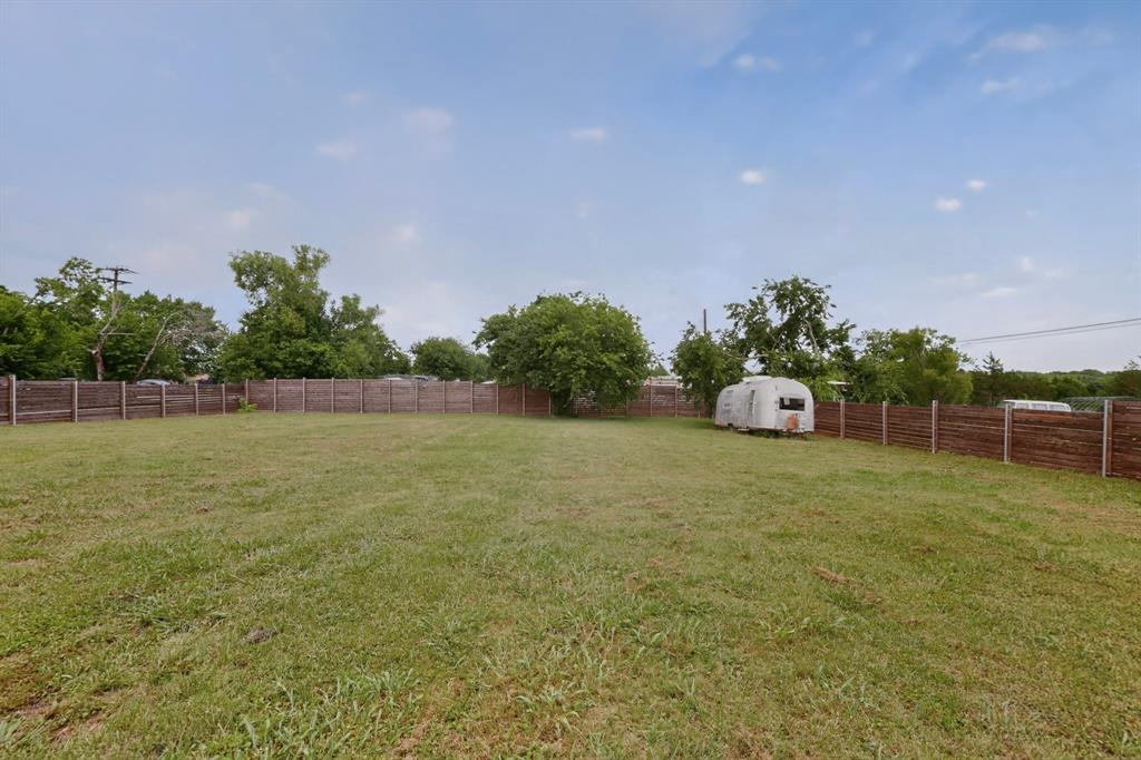 304 East County Line Road Royse City, TX 75189 - Photo 25 of 38 Expansive backyard featuring a gravel patio, stone fire pit, string lighting, and raised garden beds