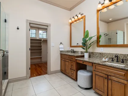 a spacious bathroom with a granite countertop sink and a mirror