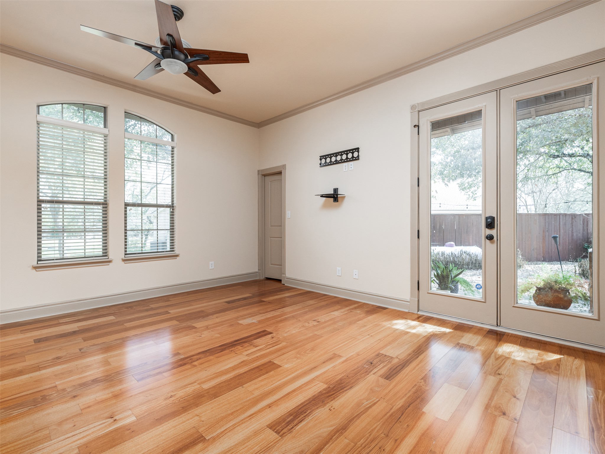 139 Ware Drive Buda, TX 78610 - Photo 25 of 39 Empty room featuring french doors, ornamental molding, light wood-style floors, and ceiling fan