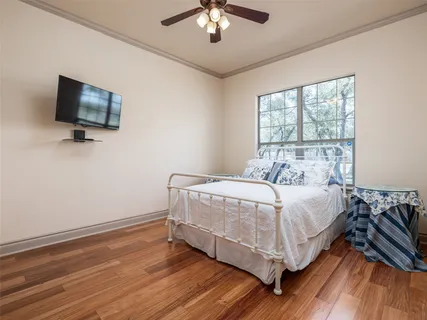 a large white bed in a room next to a window