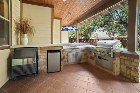 a kitchen with a stove a sink and a refrigerator