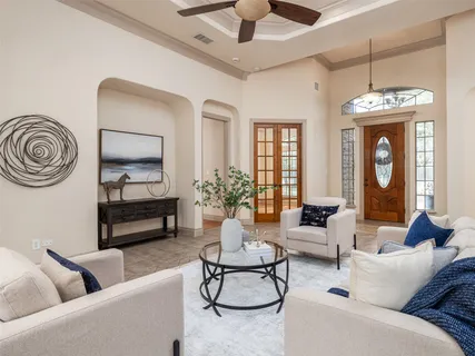 a living room with furniture a chandelier and a fireplace