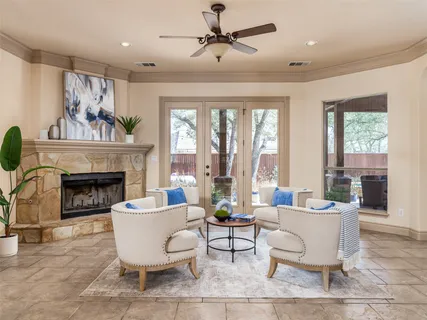a living room with furniture a fireplace and a large window