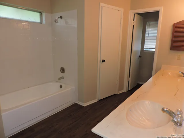 a bathroom with a tub and a sink