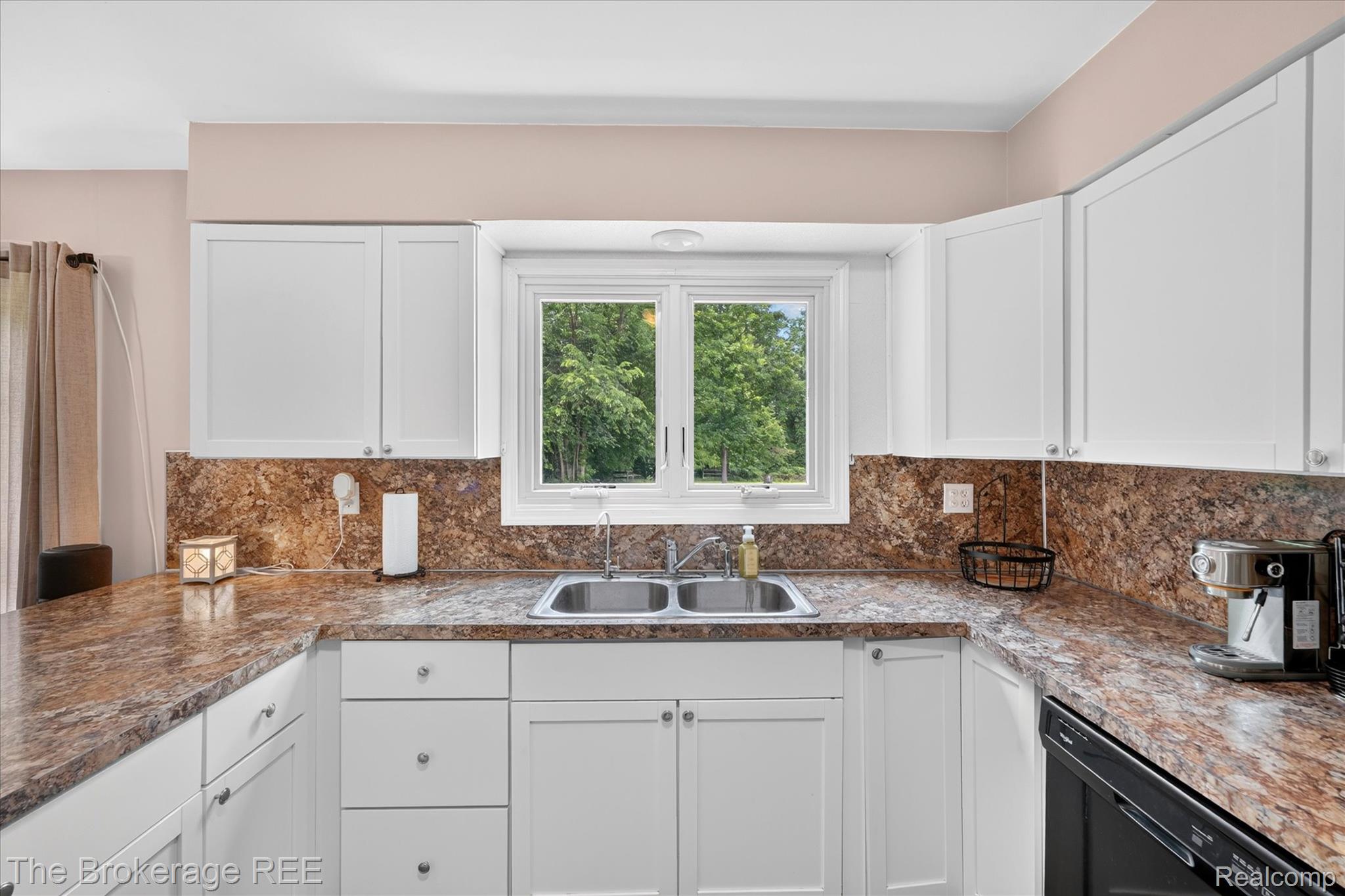 13269 North Genesee Road Clio, MI 48420 - Photo 20 of 67 Kitchen featuring white cabinetry with brushed nickel hardware, a double basin stainless steel sink, and a patterned countertop extending to a backsplash
