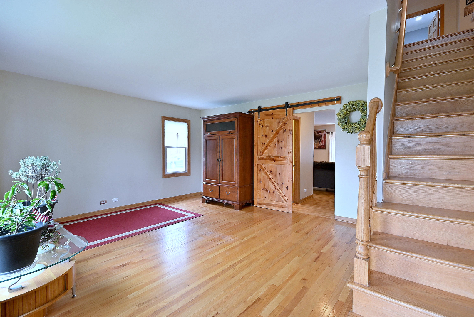 1495 East Algonquin Road Des Plaines, IL 60016 - Photo 18 of 41 a view of an empty room with wooden floor and a window