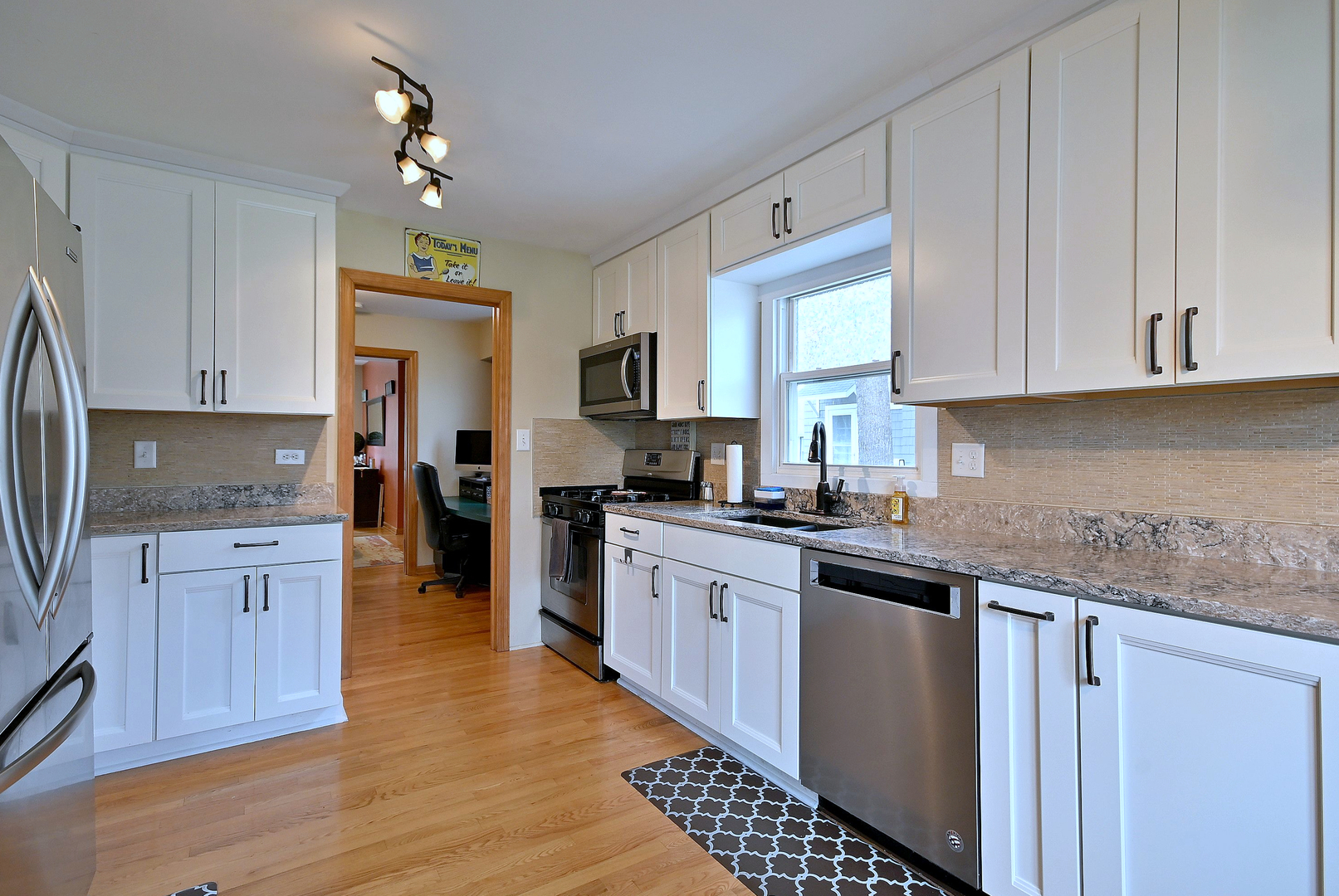 1495 East Algonquin Road Des Plaines, IL 60016 - Photo 20 of 41 a kitchen with stainless steel appliances granite countertop a stove a sink dishwasher and a refrigerator with wooden floor