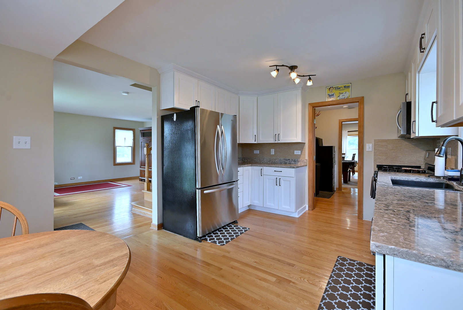 1495 East Algonquin Road Des Plaines, IL 60016 - Photo 21 of 41 a kitchen with stainless steel appliances granite countertop a refrigerator and a stove top oven