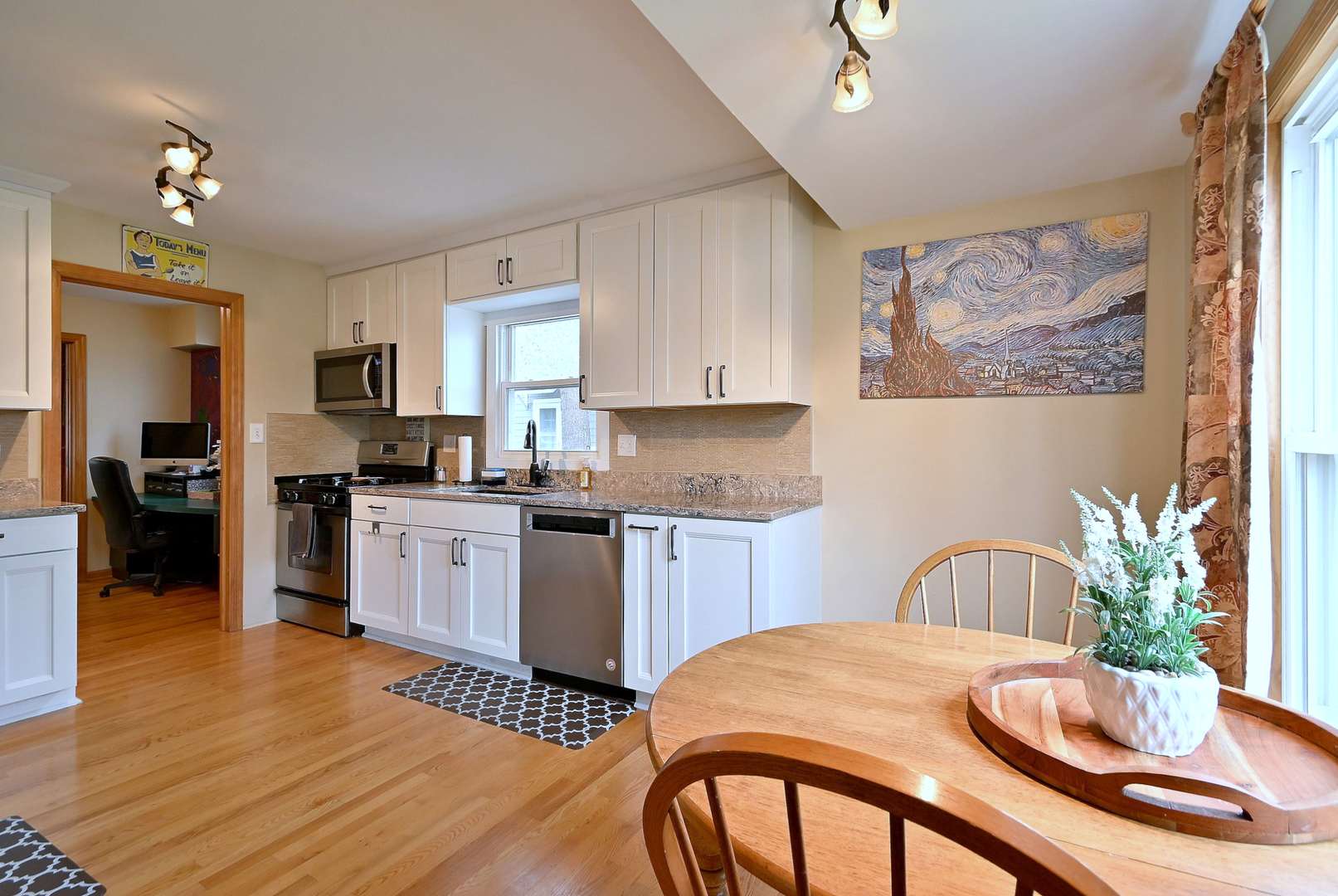 1495 East Algonquin Road Des Plaines, IL 60016 - Photo 22 of 41 a kitchen with a table chairs a refrigerator and a stove top oven