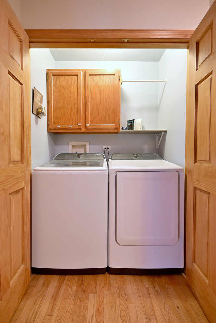 1495 East Algonquin Road Des Plaines, IL 60016 - Photo 27 of 41 a utility room with a sink a wooden floor and a window