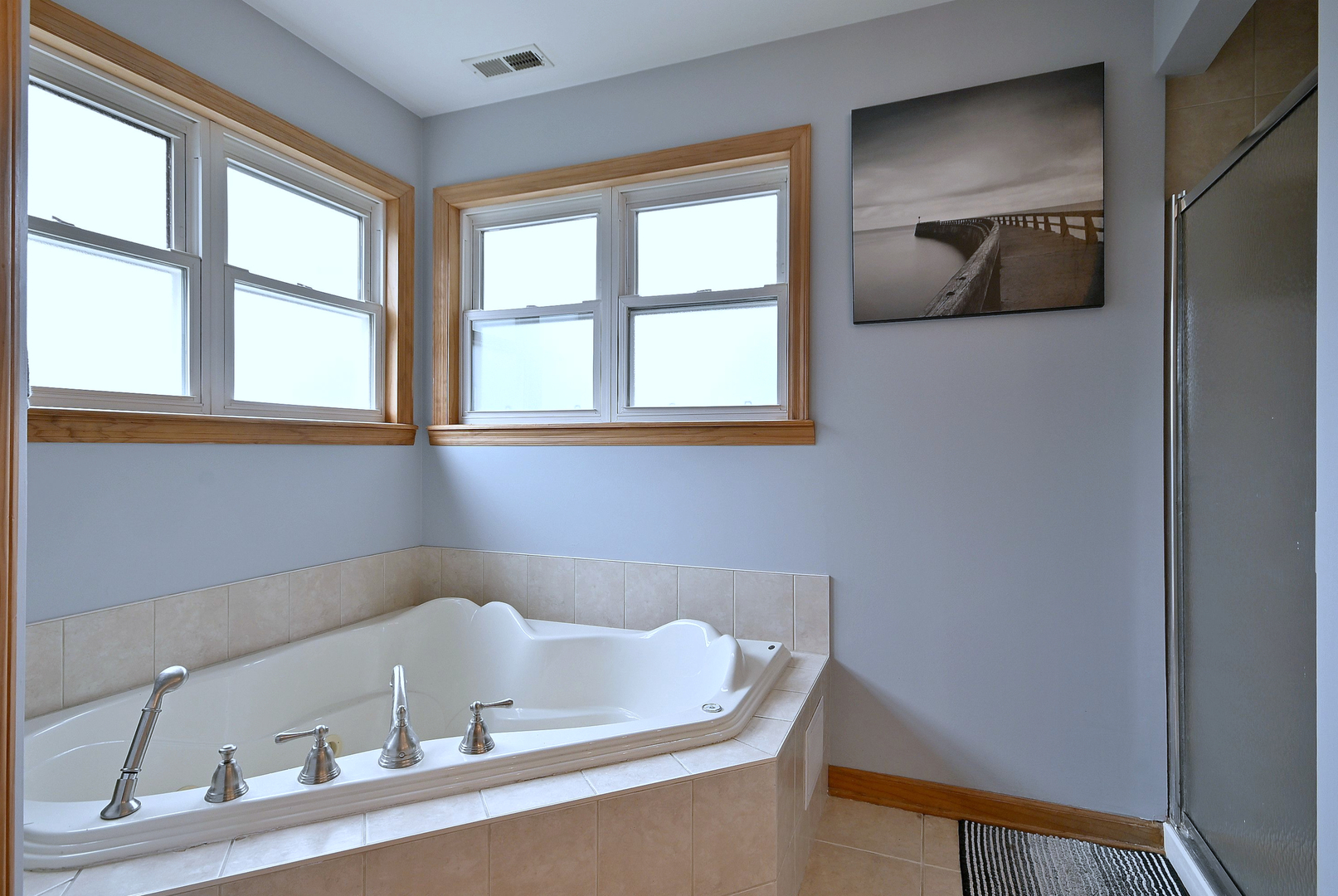 1495 East Algonquin Road Des Plaines, IL 60016 - Photo 37 of 41 a bath tub sitting in a bathroom next to a window
