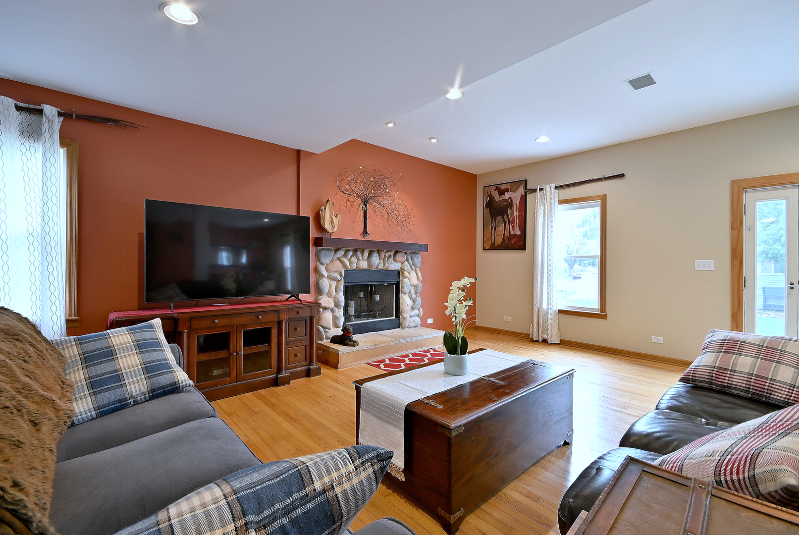 1495 East Algonquin Road Des Plaines, IL 60016 - Photo 7 of 41 a living room with furniture a flat screen tv and a fireplace
