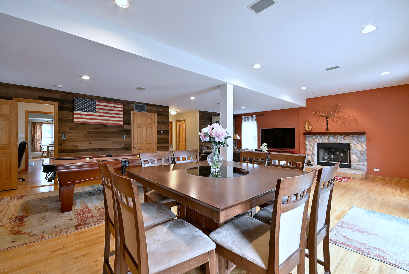 1495 East Algonquin Road Des Plaines, IL 60016 - Photo 10 of 41 a dining room with furniture a flat screen tv and a view of kitchen