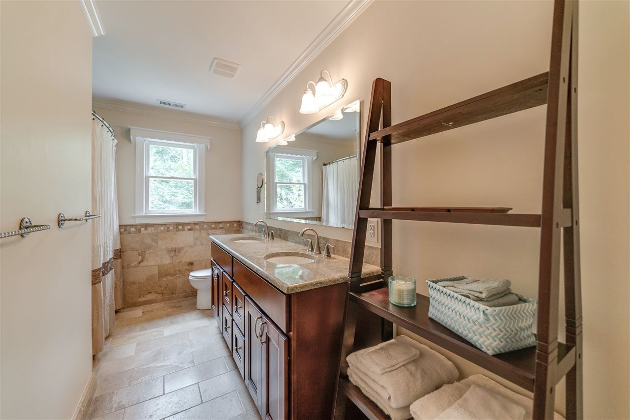 9301 Foxburrow Court Raleigh, NC 27613 - Photo 18 of 25 Tastefully updated shared bathroom with dual sinks and large tub/shower combo! Shared Bathroom