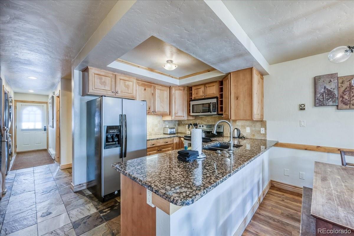 200 North Ridge Street, Unit R1 Breckenridge, CO 80424 - Photo 6 of 27 a kitchen with stainless steel appliances granite countertop a refrigerator a stove and a sink with granite countertops