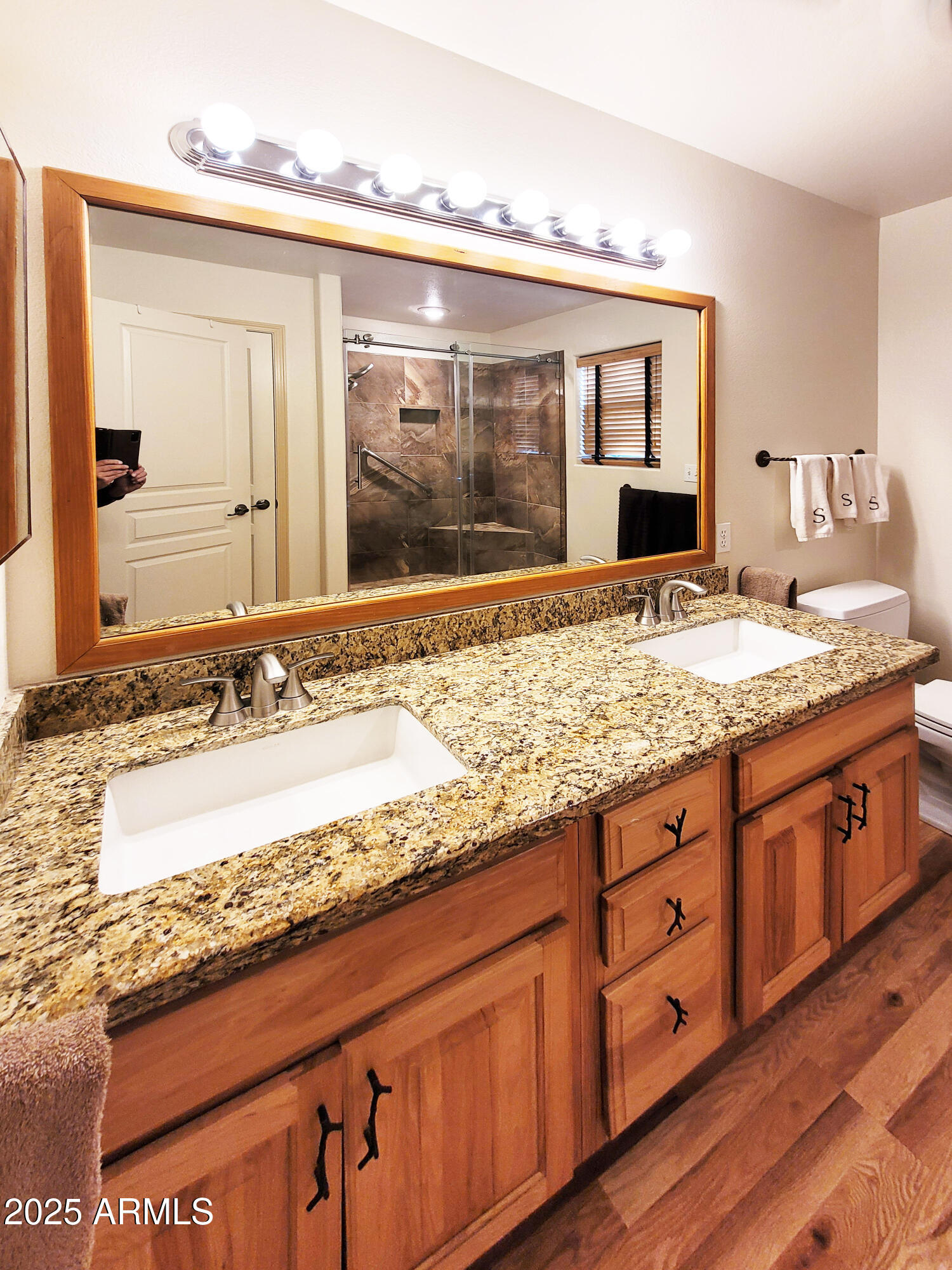 5579 Solitude Trail Loop Pine, AZ 85544 - Photo 31 of 50 a bathroom with a granite countertop sink and a large mirror