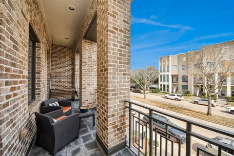 a view of a balcony with couches and wooden floor
