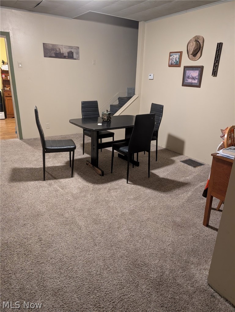 3 South 2nd Street Dennison, OH 44621 - Photo 6 of 16 Dining space with light colored carpet and stairway
