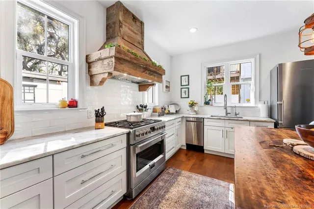 a living room with furniture potted plant and a table