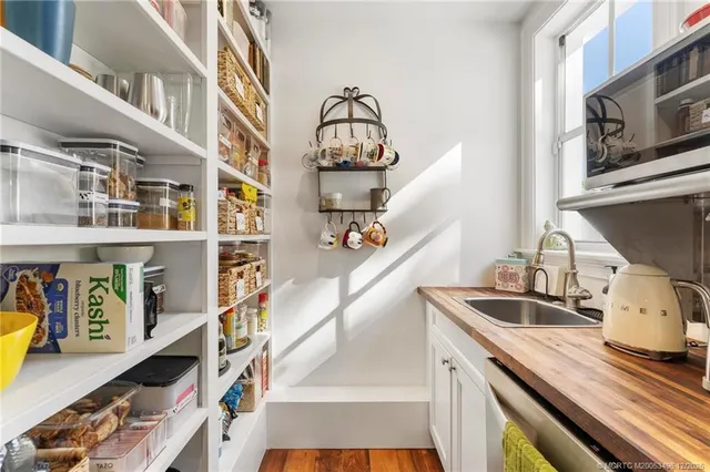 a view of a room with furniture and wooden floor