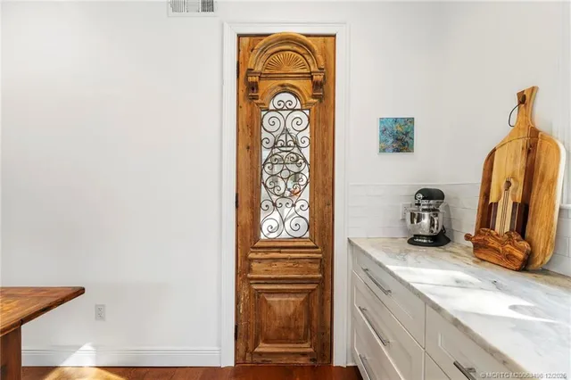 a bedroom with a bed lamp on desk and a window