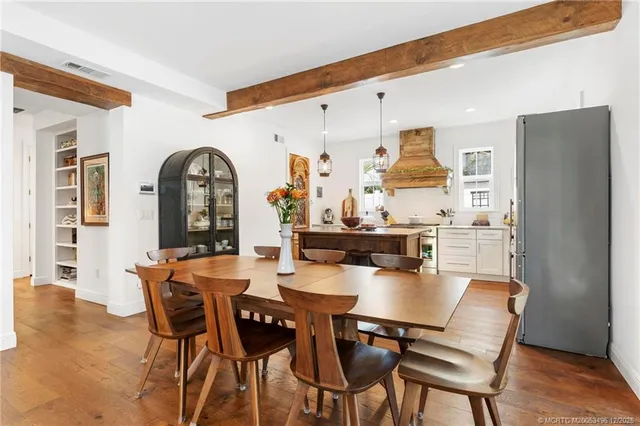 a bedroom with a bed and a table in it with wooden floor