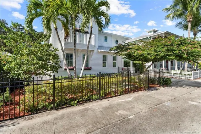a white house with potted plants and a potted plant