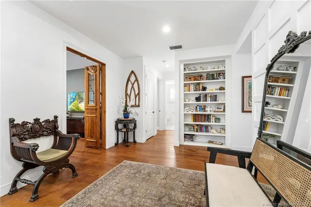 a view of a backyard with table and chairs couches wooden floor and fence