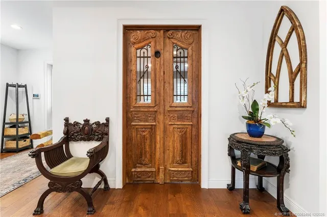 a living room with patio furniture and a wooden floor