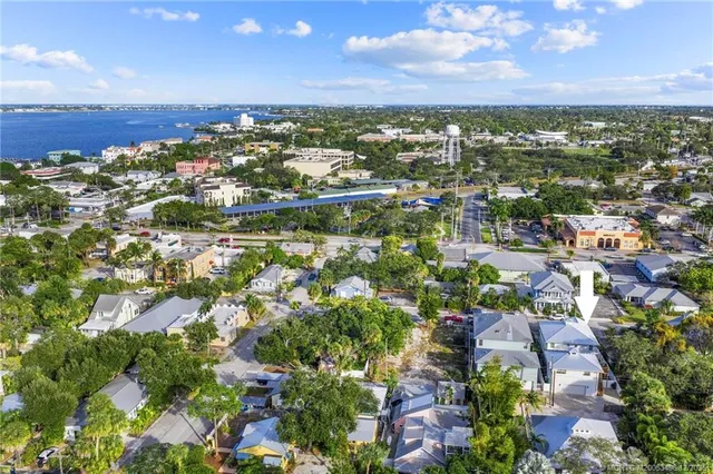 a kitchen with stainless steel appliances granite countertop a sink a stove a refrigerator and island with wooden floor