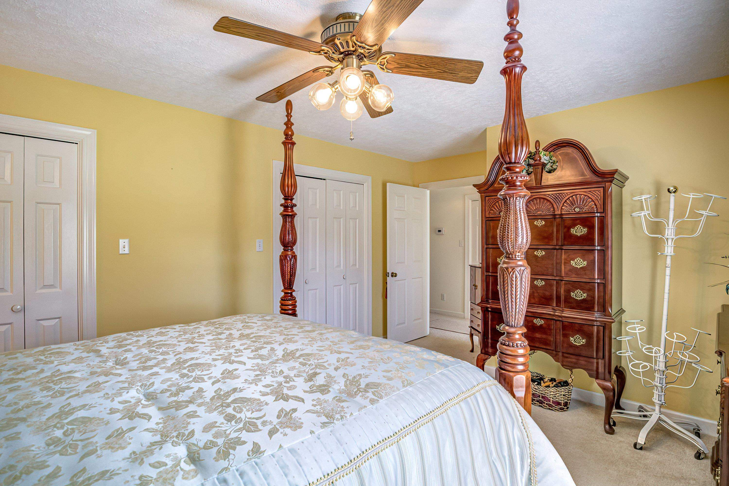 7191 Suttontown Road Faison, NC 28341 - Photo 17 of 40 a bedroom with a bed and a chandelier