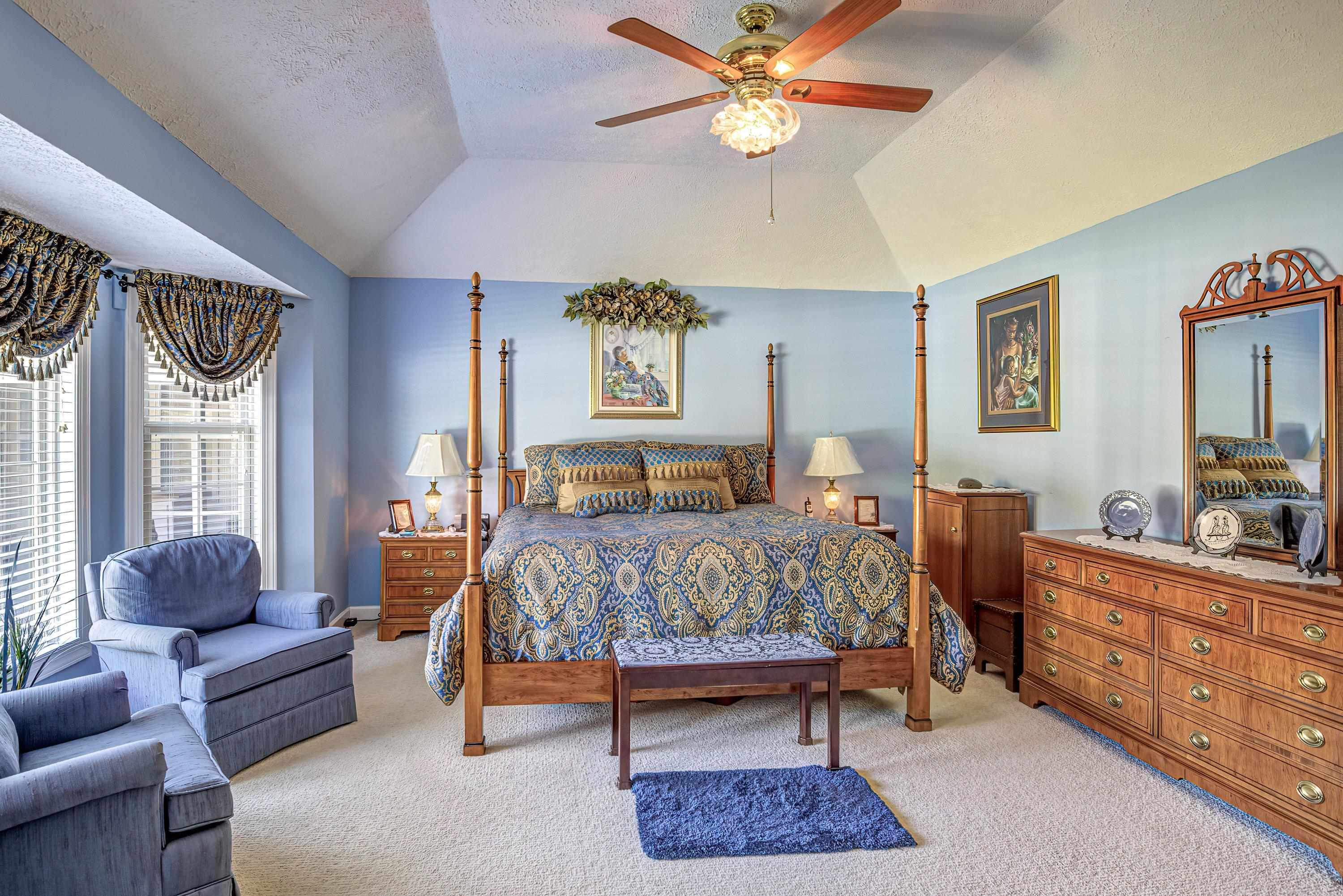 7191 Suttontown Road Faison, NC 28341 - Photo 24 of 40 a bedroom with a bed a couch and dresser