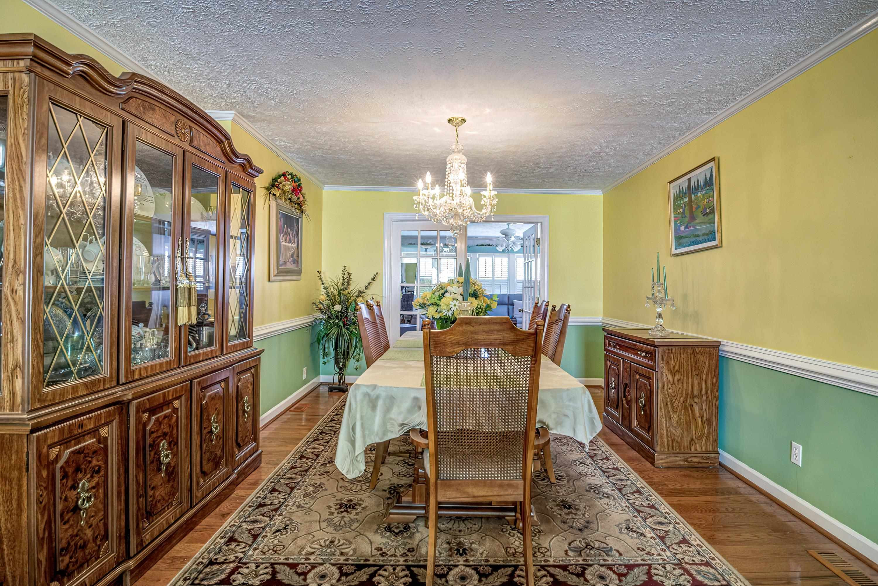 7191 Suttontown Road Faison, NC 28341 - Photo 25 of 40 a dining room with furniture a chandelier and wooden floor