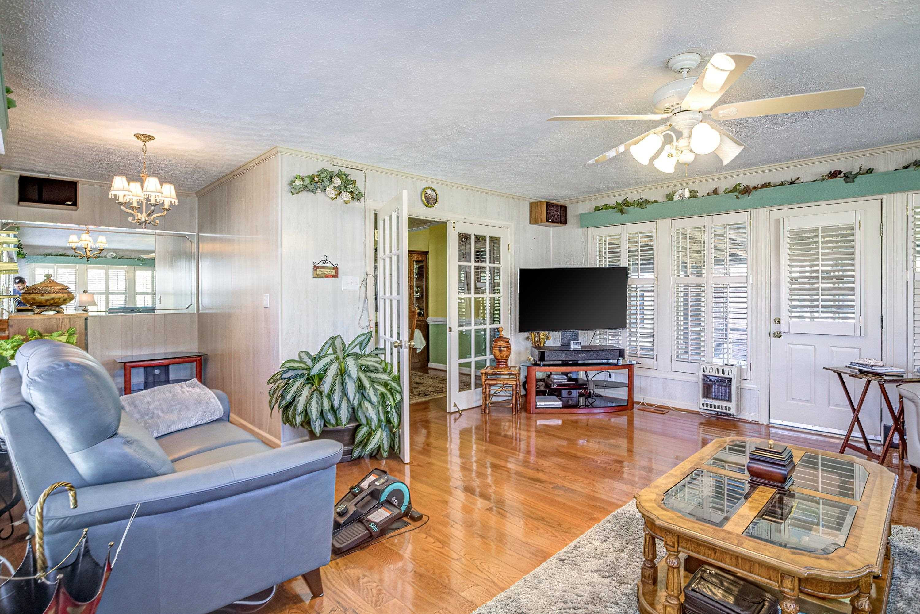 7191 Suttontown Road Faison, NC 28341 - Photo 28 of 40 a living room with furniture a flat screen tv and a large window