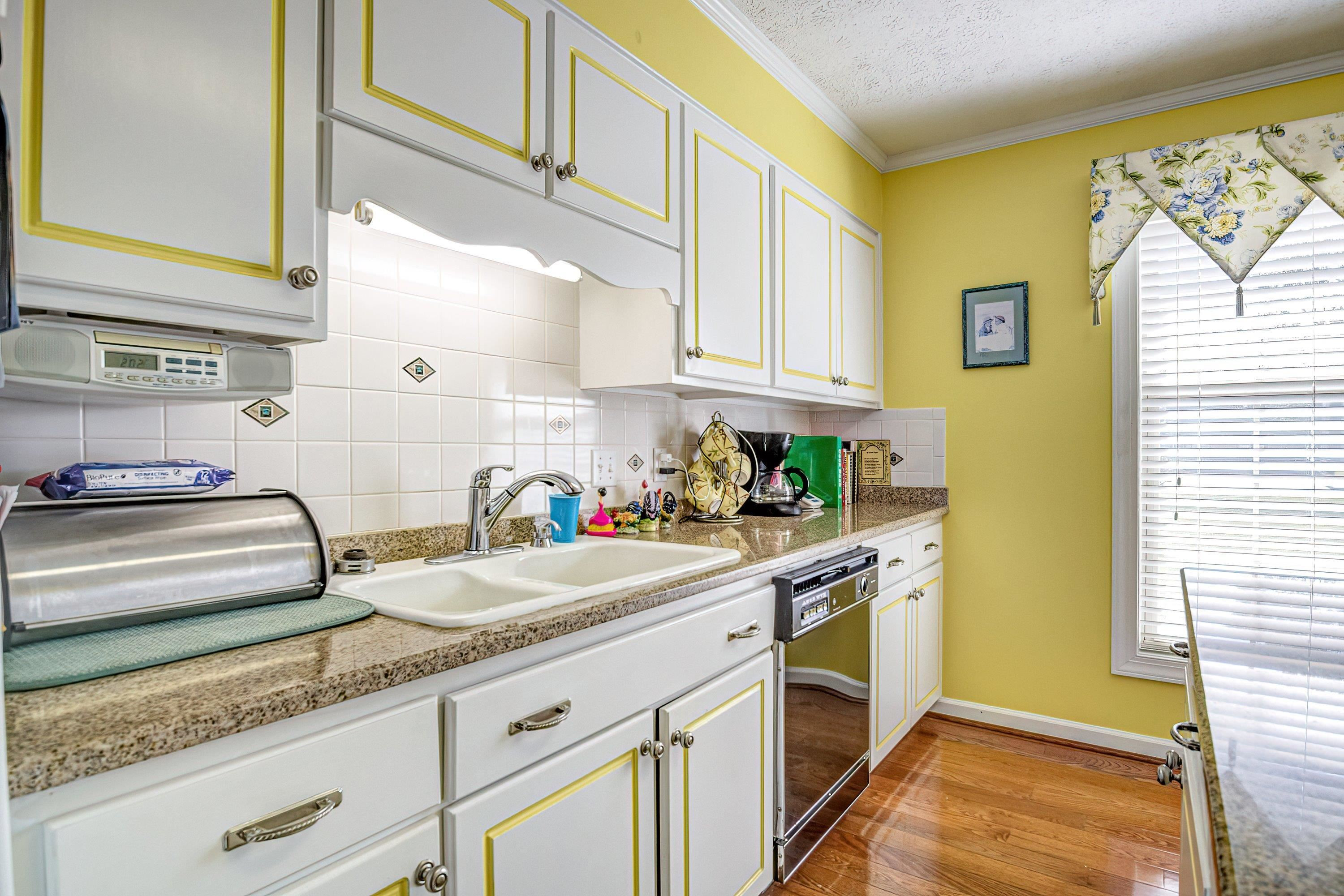 7191 Suttontown Road Faison, NC 28341 - Photo 29 of 40 a kitchen with granite countertop stainless steel appliances a sink window and cabinets