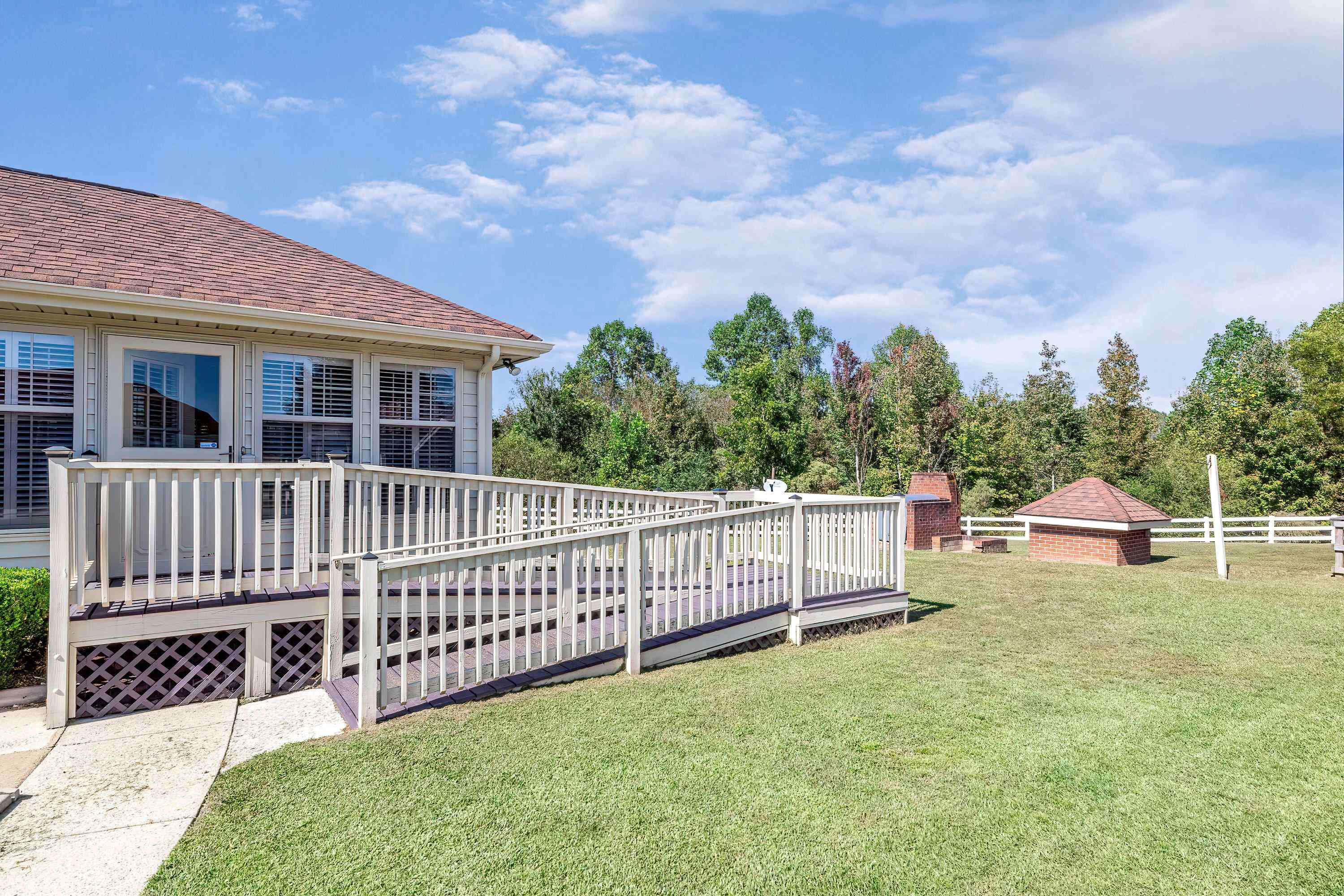7191 Suttontown Road Faison, NC 28341 - Photo 3 of 40 a view of a house with wooden deck and a yard