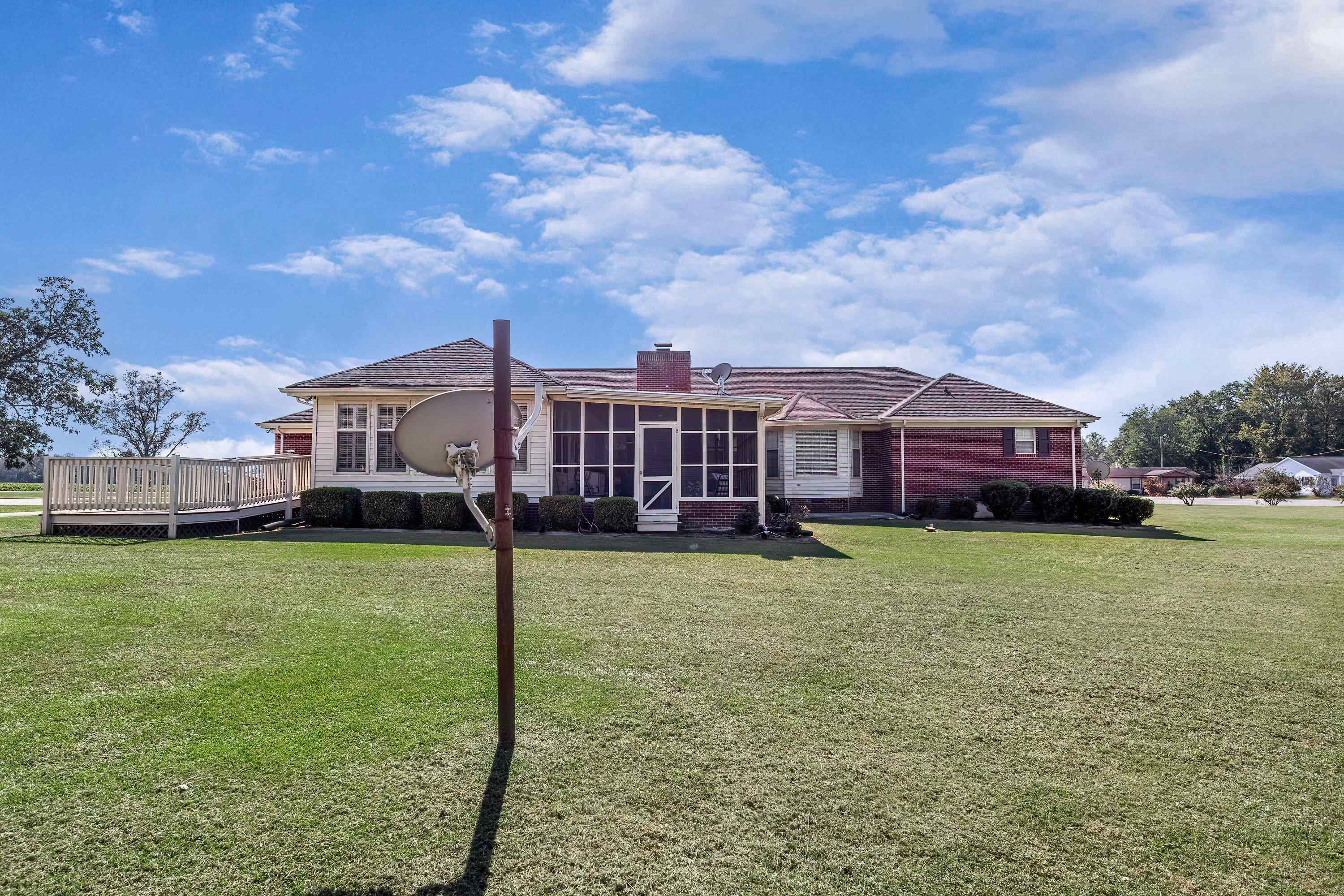 7191 Suttontown Road Faison, NC 28341 - Photo 5 of 40 a front view of a house with a garden