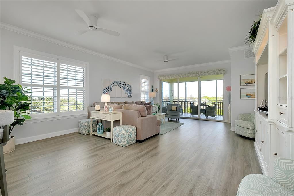 10501 Amberjack Way, Unit 301 Englewood, FL 34224 - Photo 14 of 76 a living room with furniture wooden floor and a large window