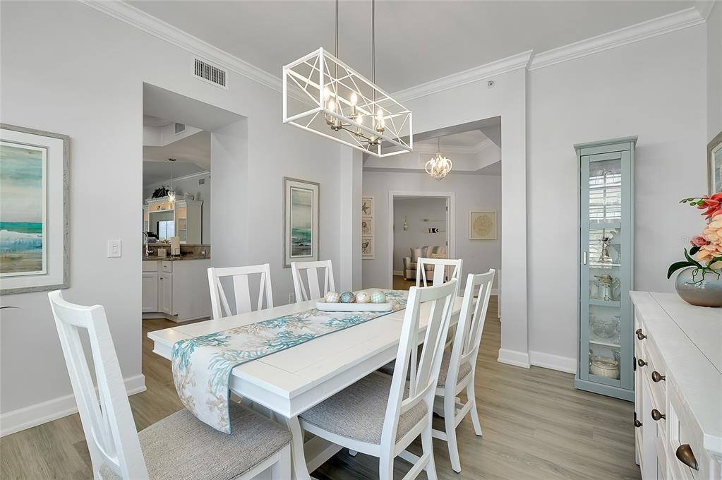 10501 Amberjack Way, Unit 301 Englewood, FL 34224 - Photo 18 of 76 a view of a dining room with furniture and wooden floor