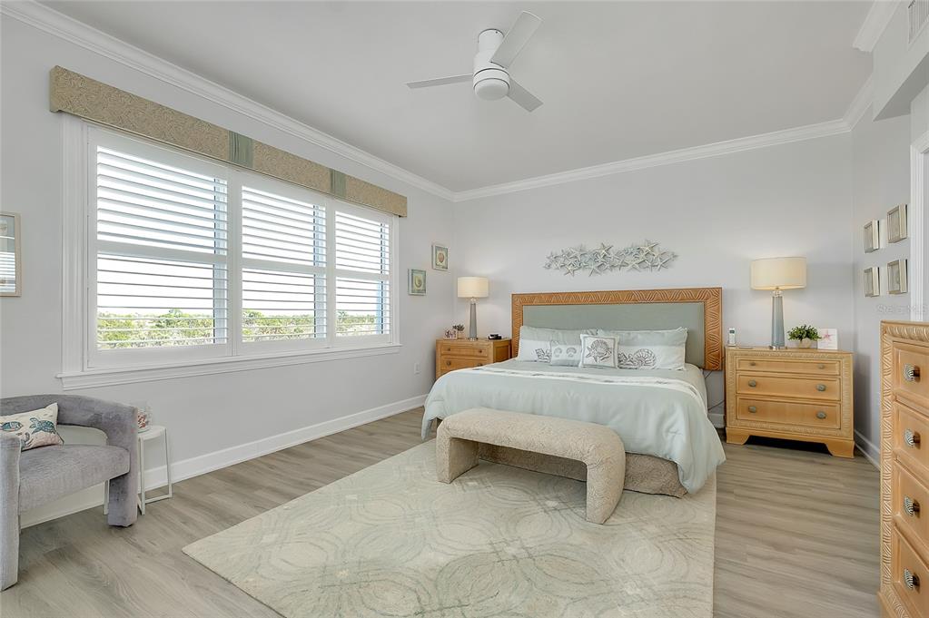 10501 Amberjack Way, Unit 301 Englewood, FL 34224 - Photo 19 of 76 a bedroom with a bed and wooden floor