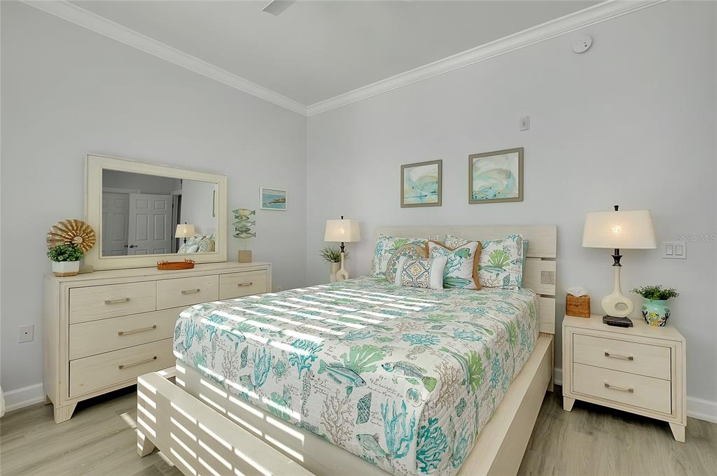 10501 Amberjack Way, Unit 301 Englewood, FL 34224 - Photo 29 of 76 a bedroom with a bed and a dresser