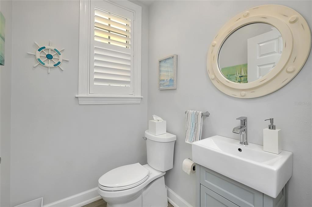 10501 Amberjack Way, Unit 301 Englewood, FL 34224 - Photo 32 of 76 a bathroom with a toilet a sink and a mirror