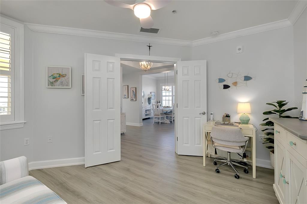 10501 Amberjack Way, Unit 301 Englewood, FL 34224 - Photo 36 of 76 a living room with furniture and a chandelier