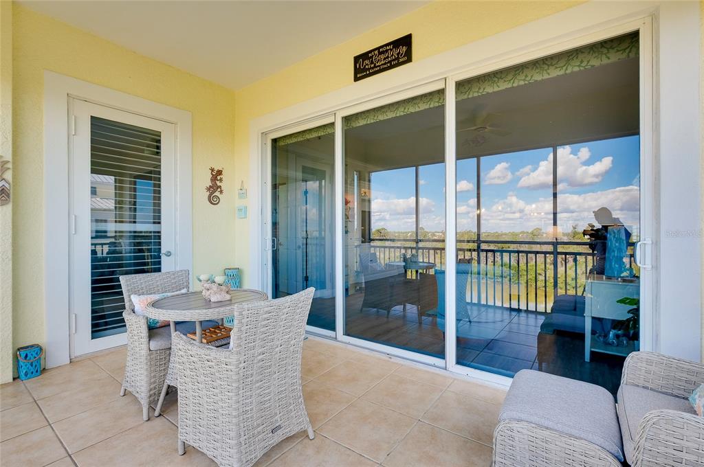 10501 Amberjack Way, Unit 301 Englewood, FL 34224 - Photo 40 of 76 a dining room with furniture water view and a floor to ceiling window