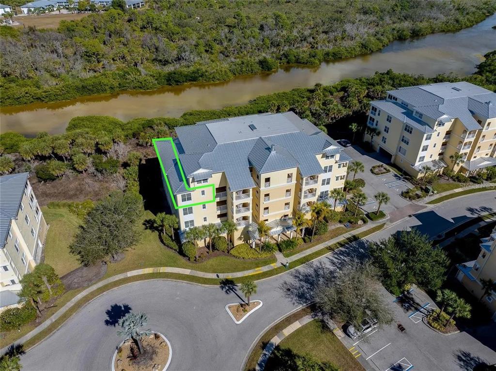 10501 Amberjack Way, Unit 301 Englewood, FL 34224 - Photo 48 of 76 an aerial view of a house with a garden and lake view