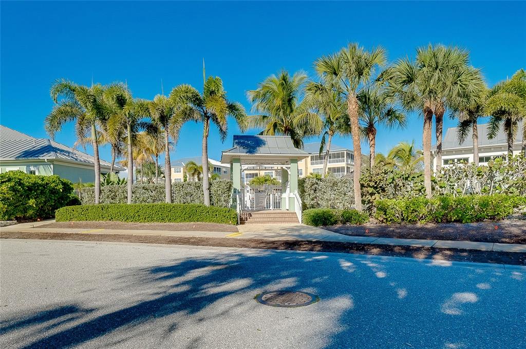 10501 Amberjack Way, Unit 301 Englewood, FL 34224 - Photo 53 of 76 a front view of a house with a yard and a garage