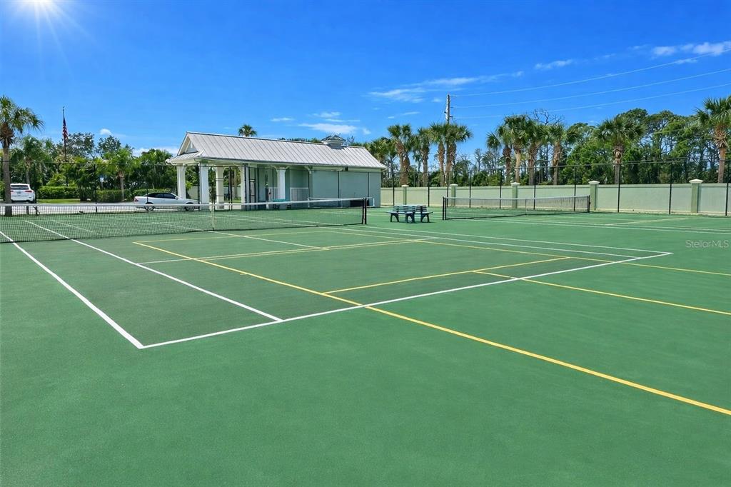 10501 Amberjack Way, Unit 301 Englewood, FL 34224 - Photo 74 of 76 a view of a tennis ground with large trees