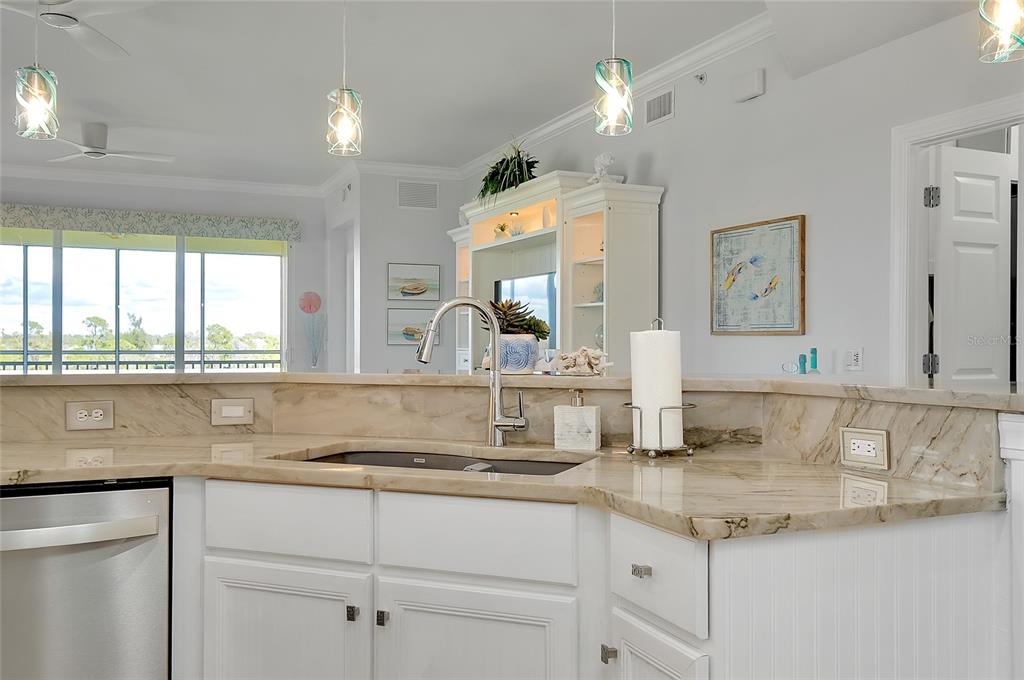 10501 Amberjack Way, Unit 301 Englewood, FL 34224 - Photo 8 of 76 a kitchen with stainless steel appliances granite countertop a sink and a white cabinets