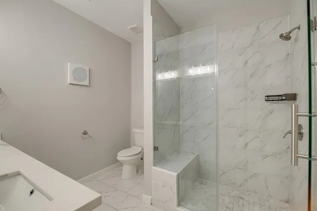 a bathroom with a toilet and a shower